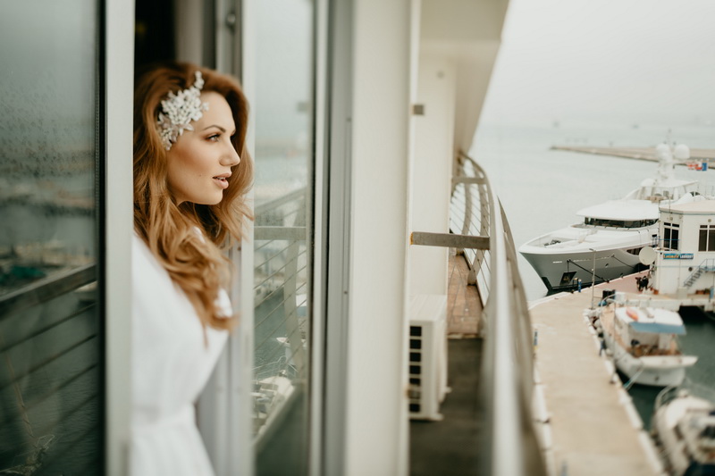 malaga beach wedding - bride looking on the window